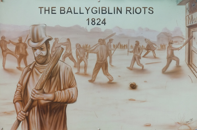 mural commemorating the Ballygiblin Riots of 1824, done in sepia tones, men in clothing of the time with bats as weapons