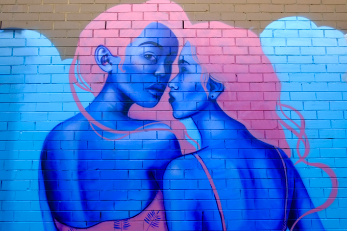 street art mural in Mirka Lane, St. Kilda, these pink-haired women with blue skin were painted by Bronik