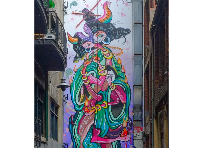  large mural by Jaz Mishap at the end wall, two Asian (Japanese?) women entwined.  title of mural is Chopsticks