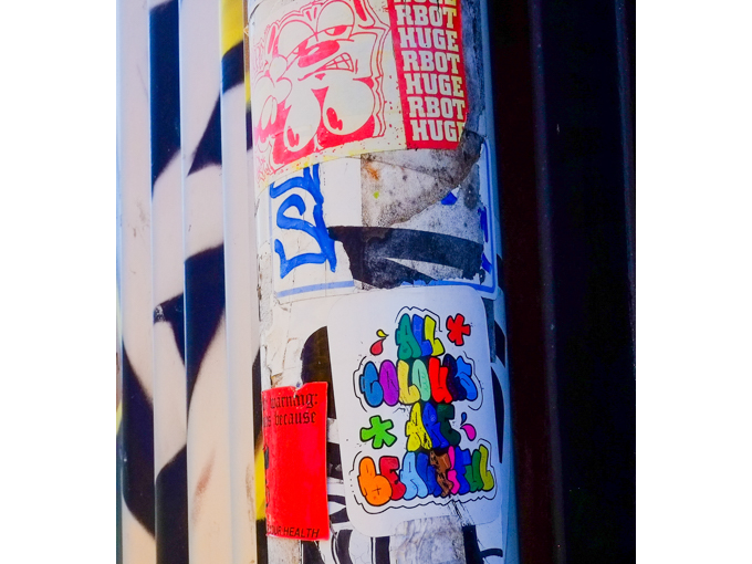 graffiti including one piece that has text that says all colours are beautiful