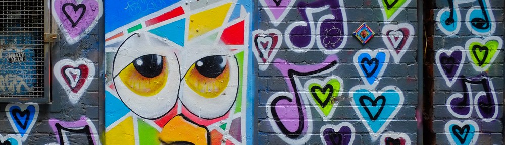 street art painting by artist called temporary of an abstract face, surrounded by graffiti hearts painted on the walls, Drewery Lane, Melbourne