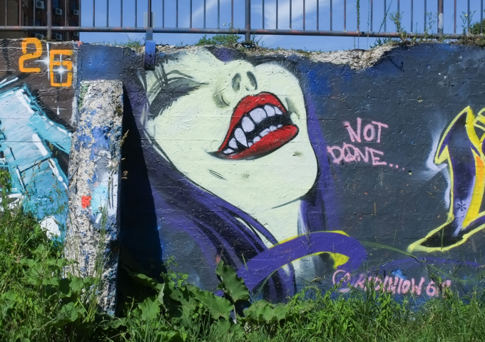 mural, wicked face of a woman with red lipstick