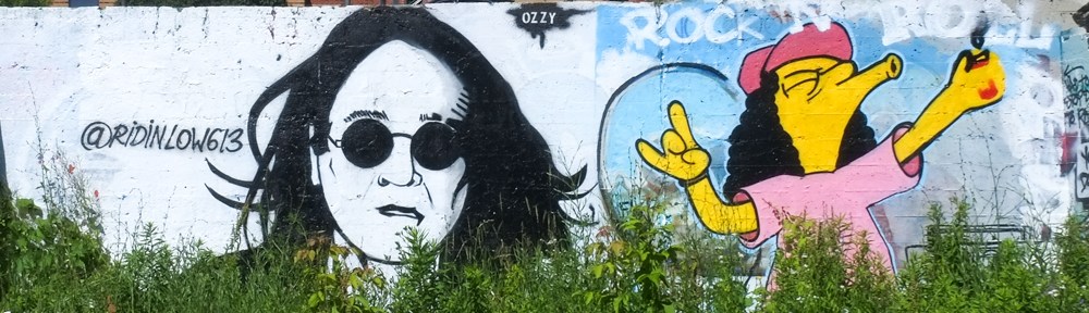 kingston graffiti wall, two paintings, one of ozzy osborne and one a character from the simpsons TV show