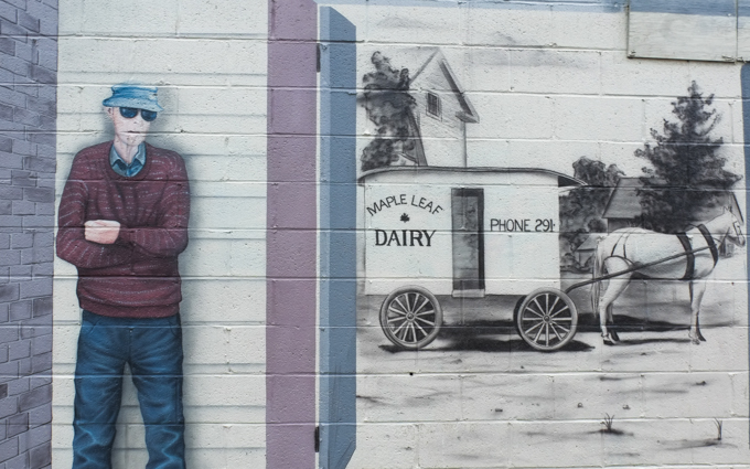 mural dedicated to Wayne Richards, milkman, also known as wandering Wayne, shown with an old horse drawn wagon milk cart from Maple Leaf dairy