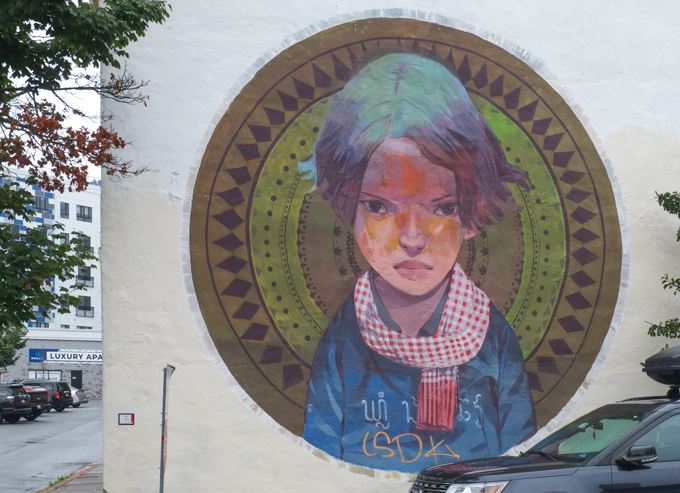 street art mural in Lynn Massachusetts, portrait of a young person in a circular medallion, by Andrew Hem