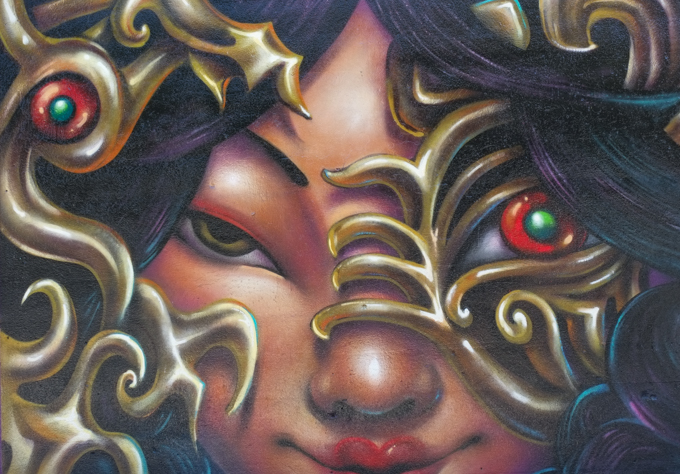 street art mural on wall of railway underpass on Bloor street West by Monk Yi, woman wearing a mask that has one red eye