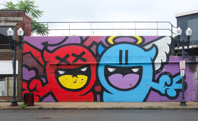 street art mural in Lynn Massachusetts by Golden 305, a red devil monster and a blue angel monster, title in equilibrium