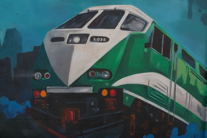 street art mural on wall of railway underpass on Bloor street West, image of a GO train engine