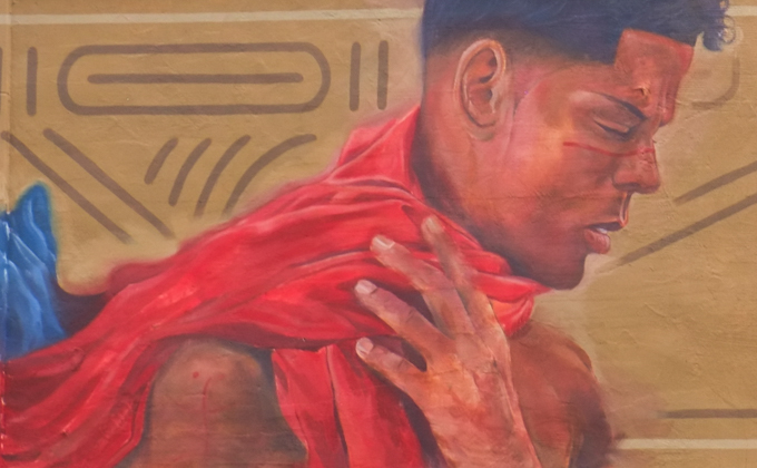 street art mural in Lynn Massachusetts, by Medio Peso, on upper level of building, above a store