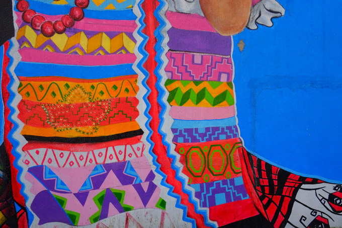 part of a mural, Dance the Dance My Girl by Ari de la Mora and Irving Cato in Vancouver, colourful patterns in fabric of a woman's clothing
