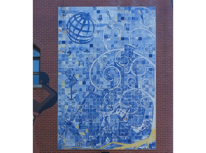 picture on exterior wall, made of blue and white tiles, lots of details