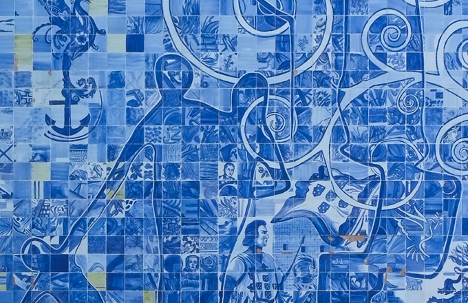 close up view of picture on exterior wall, made of blue and white tiles, lots of details