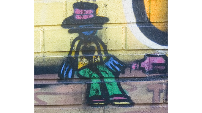 little character in Belgian mural, sitting, with a big heart on his shirt