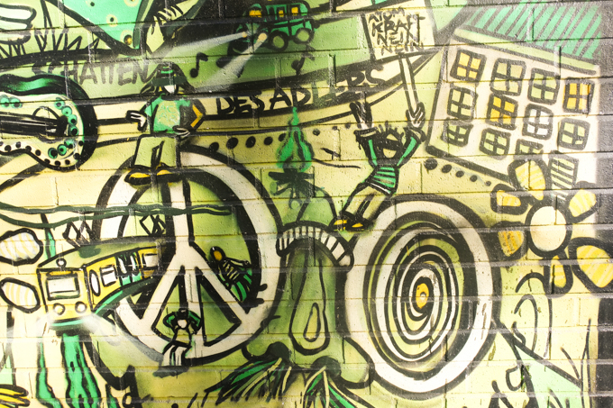 Belgian Quarter mural, peace symbols, big glasses, love