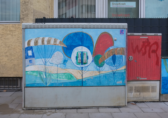 sidewalk utility box in Bonn Germany,painted, stylized trees in a forest