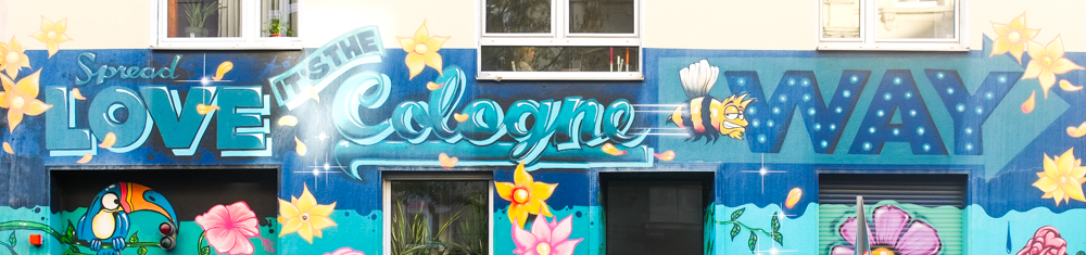 top of a street art mural in Koln Cologne Germany, text, that says spread love, it's the Cologne way