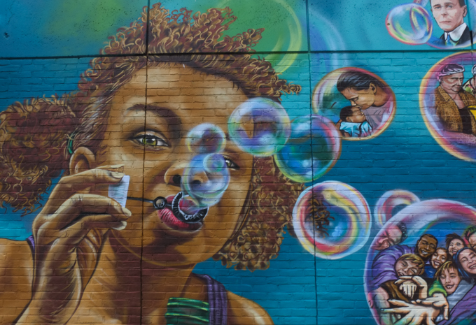young girl blowing lots of bubbles in a mural for 50th anniversary of Rotary Club of Nashua West