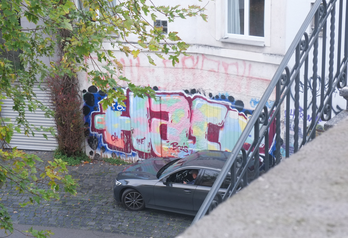 throw up tag on wall of building by a bridge, view from the bridge