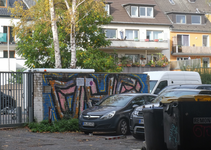 street art, graffiti on small structure by parking lot behind a building, Bonn Germany