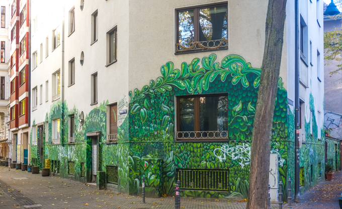 Green botanical and leaf motif wrapping around the base of the building.