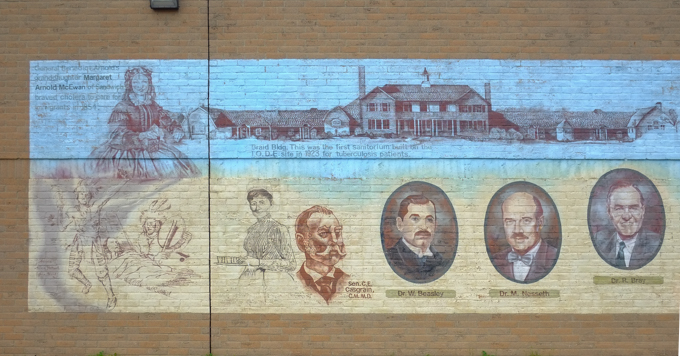 part of Healthy Communities mural with drawing of General Benedict Arnold's granddaughter, Margaret Arnold McEwan as well as Braid Building which was a Sanitorium that was built in 1923 to house tuberculosis patients
