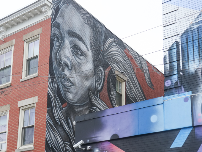 mural titled, Katherine, painted by Mexican artist Paola Delfín, large portrait in grey tones