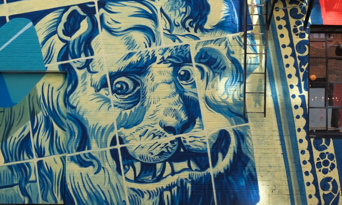 part of a mural by Kevin Ledo, blue and white face of a lion