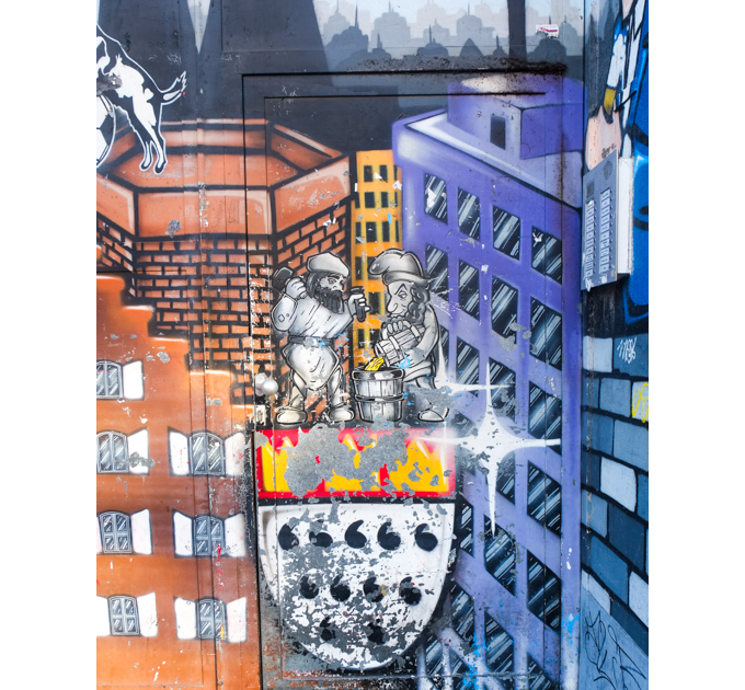 street art painting of two small men Mixing paint in a wood bucket while standing on Cologne's crest - three gold crowns above eleven flames