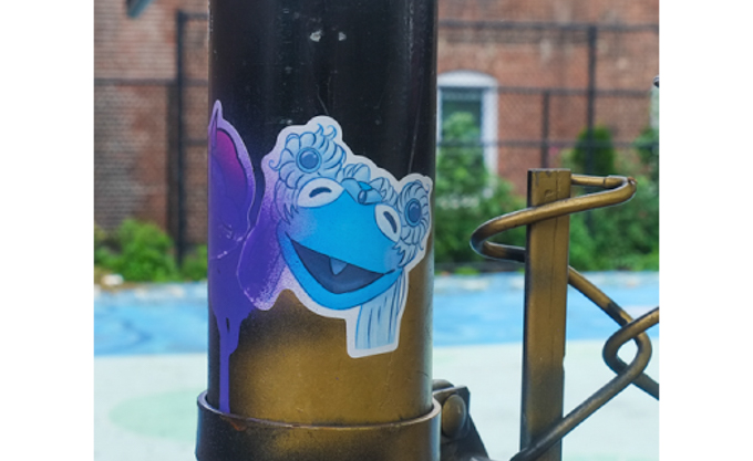 sticker graffiti, blue frog's face, laughing, with flowers in its hair 