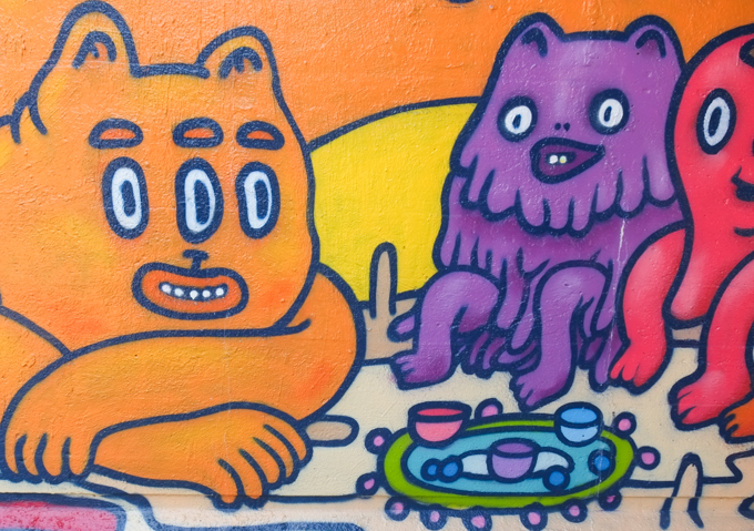 monsters having a tea party, mural by Stephanie Avery, including three eyed orange guy and purple furry guy