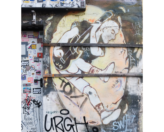 urban art, street art, in Cologne Germany, near Ehrenfeld station, faded painting of a guitar player