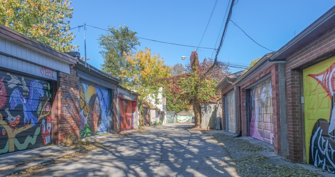 street art murals on many garage doors in Miriam Garfinkle Lane,
