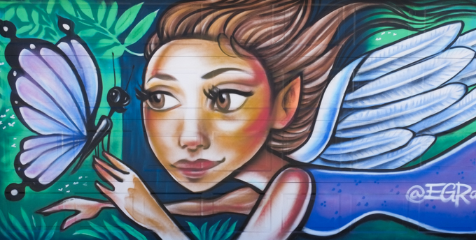 street art mural on garage door in Miriam Garfinkle Lane, by EGR, an angel and a butterfly