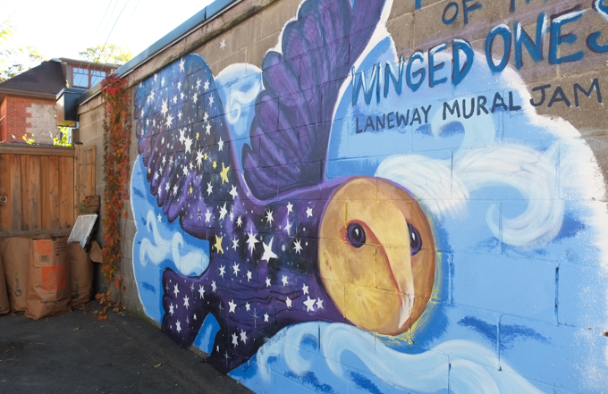 street art mural on garage door in Miriam Garfinkle Lane, purple owl in flight