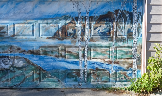 street art mural on garage door in Miriam Garfinkle Lane, by Joe rich, landscape with birch trees and water