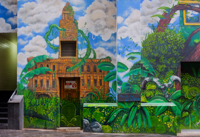 Part of a mural in Gallaghers Place in Melbourne, by Mike Makatron and Conrad Bizjak, overgrown abandoned city, Melbourne city hall