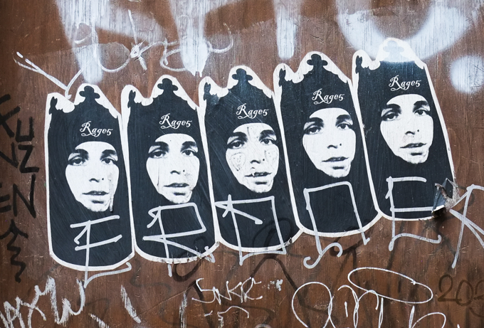 5 stencils in a row, woman in black head scarf, necks covered too, with rage5 on each head, graffiti in Montreal