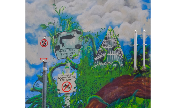 part of a mural with signthat says right turn from left lane only