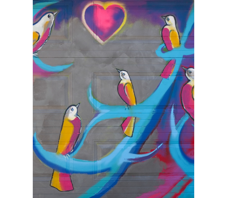 street art mural on garage door in Miriam Garfinkle Lane, pink and yellow birds on blue branches, Shoreland Arts