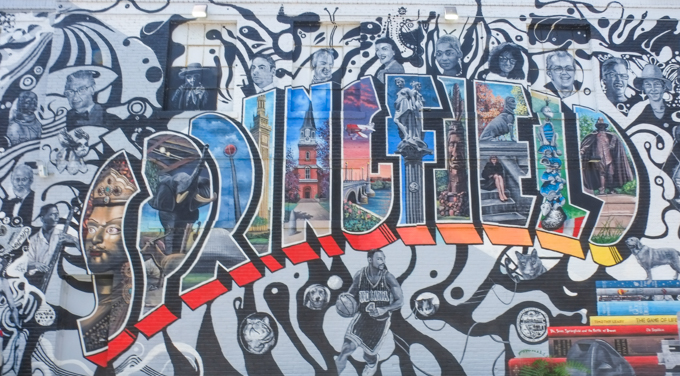mural in Springfield Massachusetts, with word Springfield in capital letters and in colour, with illustrations inside the letters and black and white images of people and things associated with the city