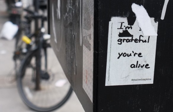 sticker graffiti, white with words written on it, I am grateful you are alive