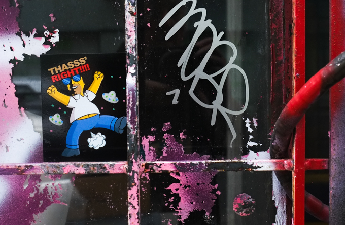 graffiti of man farting. body looks lke Homer Simpson but head is different